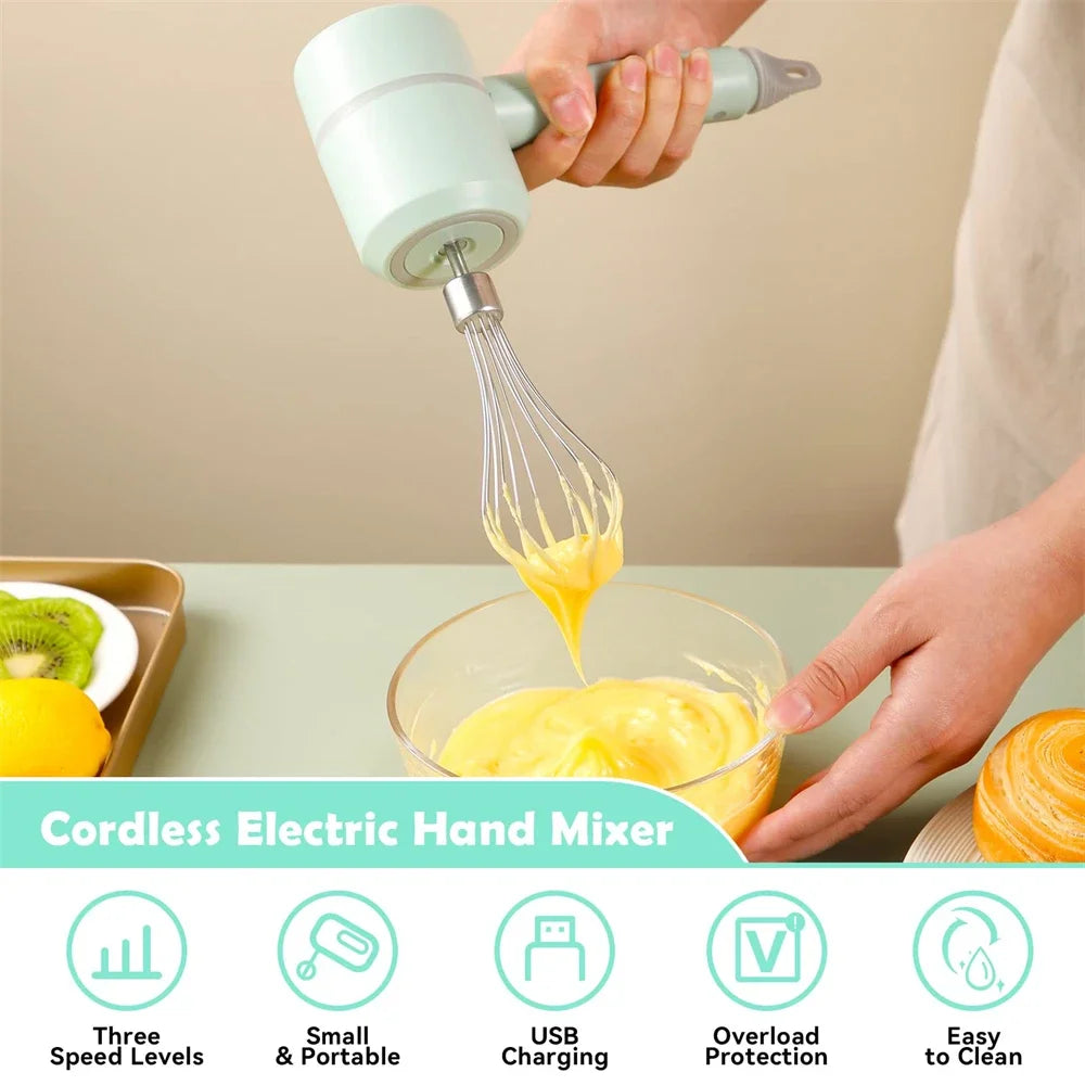 A pastel mint cordless electric hand mixer with a metal whisk, being used to mix yellow batter in a glass bowl.