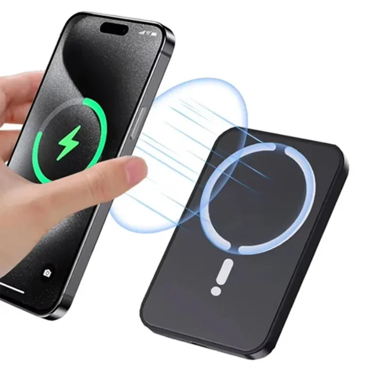 Handheld smartphone being wirelessly charged by a slim, black magnetic power bank.