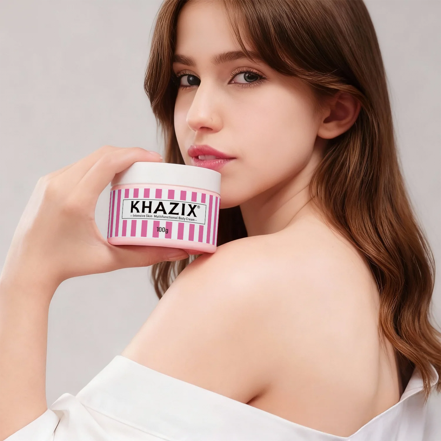 A woman holding a round 100g tub of intensive multifunctional body cream with a pink and white striped design.