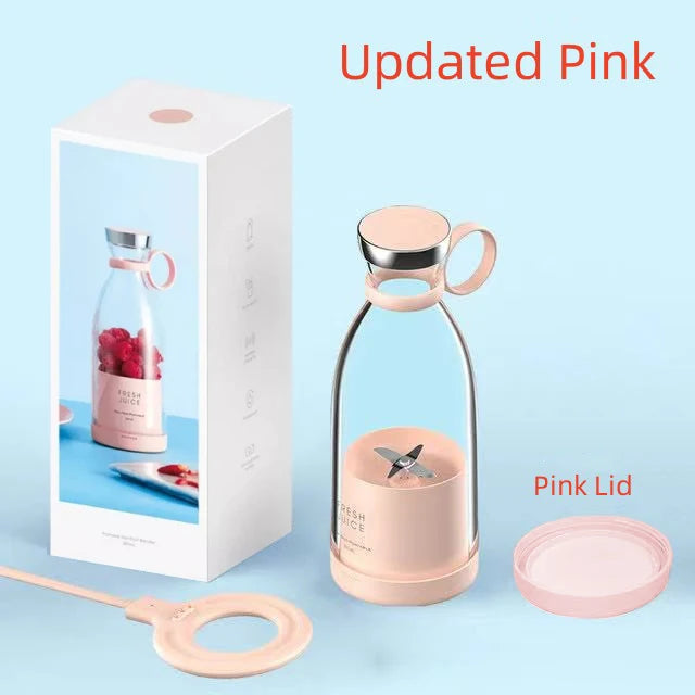 Portable pink personal blender with a glass bottle, metal base, detachable ring handle, and matching pink lid.