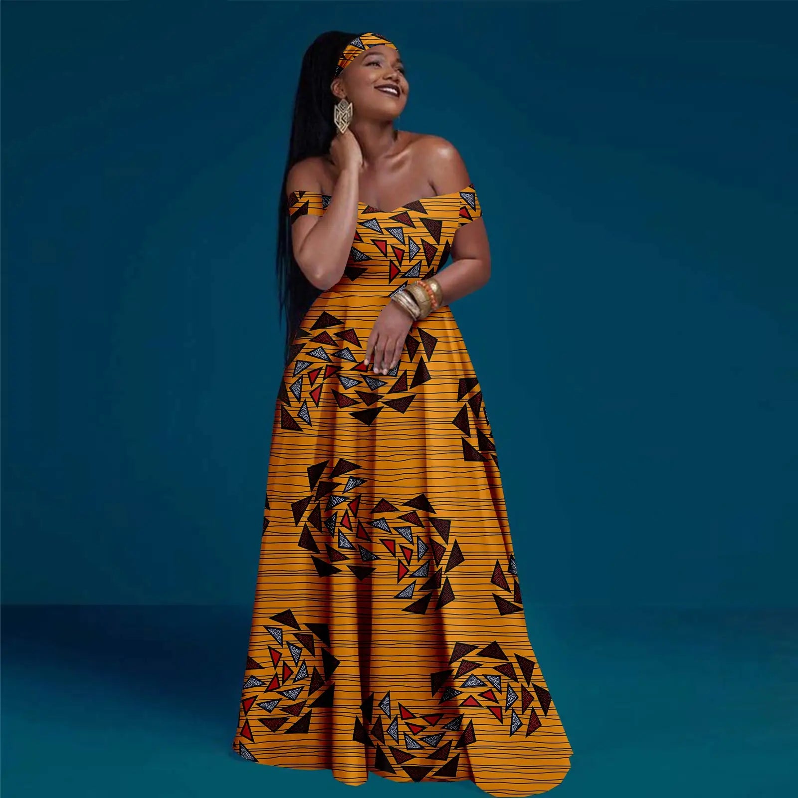 Model wearing a yellow off-shoulder maxi dress with a geometric triangle print and a matching headband.