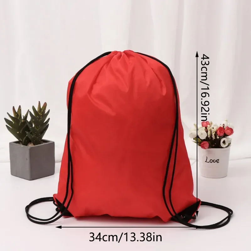 Bright red drawstring bag with black cord straps, measuring 43cm by 34cm.