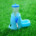 Light blue plastic small animal water bottle and food bowl combo, set on green grass.