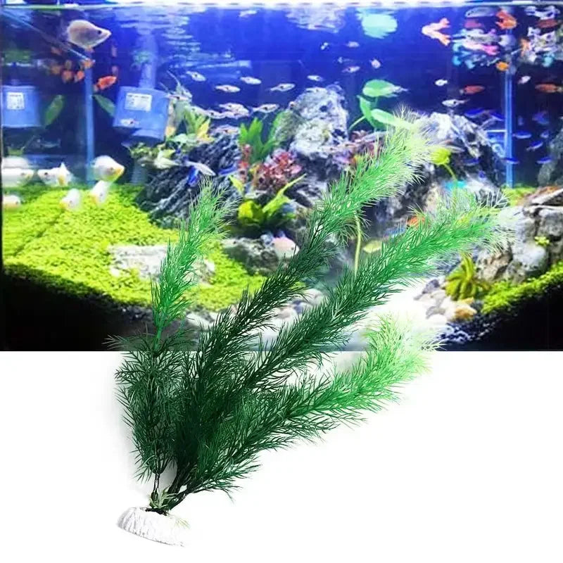 A bushy artificial green water plant with a white weighted base, shown against a background of a vibrant fish tank.