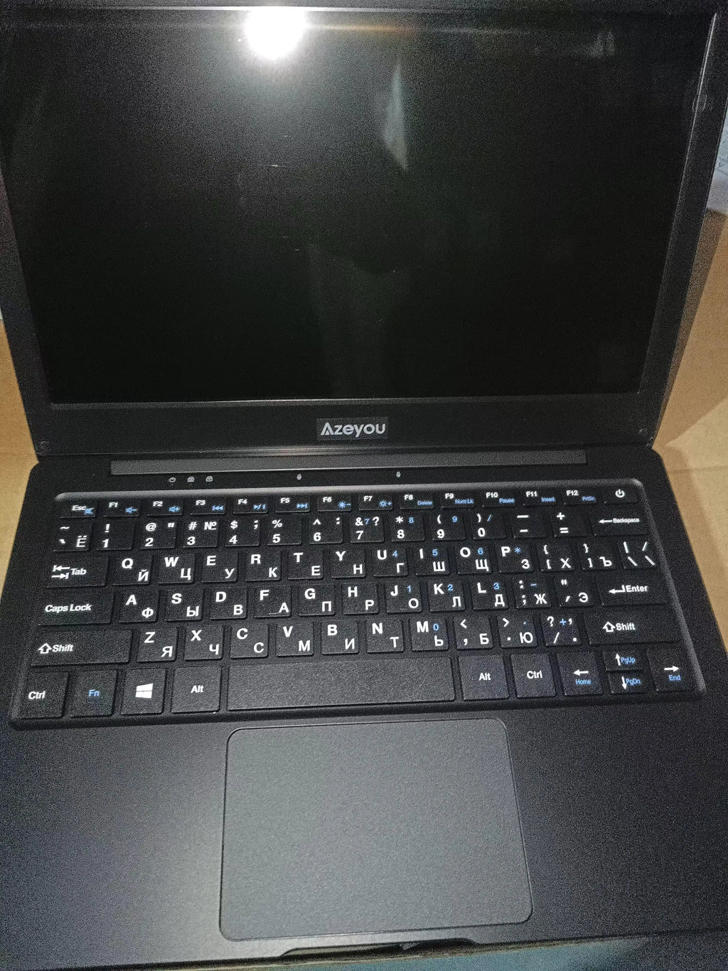 Slim black 11.6-inch laptop featuring a compact design, UK QWERTY keyboard with Cyrillic characters, and a touchpad.