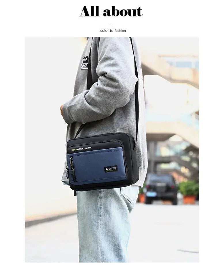 A man wearing a black and blue crossbody shoulder bag featuring a zip-front pocket and adjustable strap.