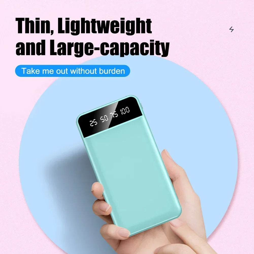 Slim, mint-green portable power bank with a black LED digital percentage display being held in a hand.
