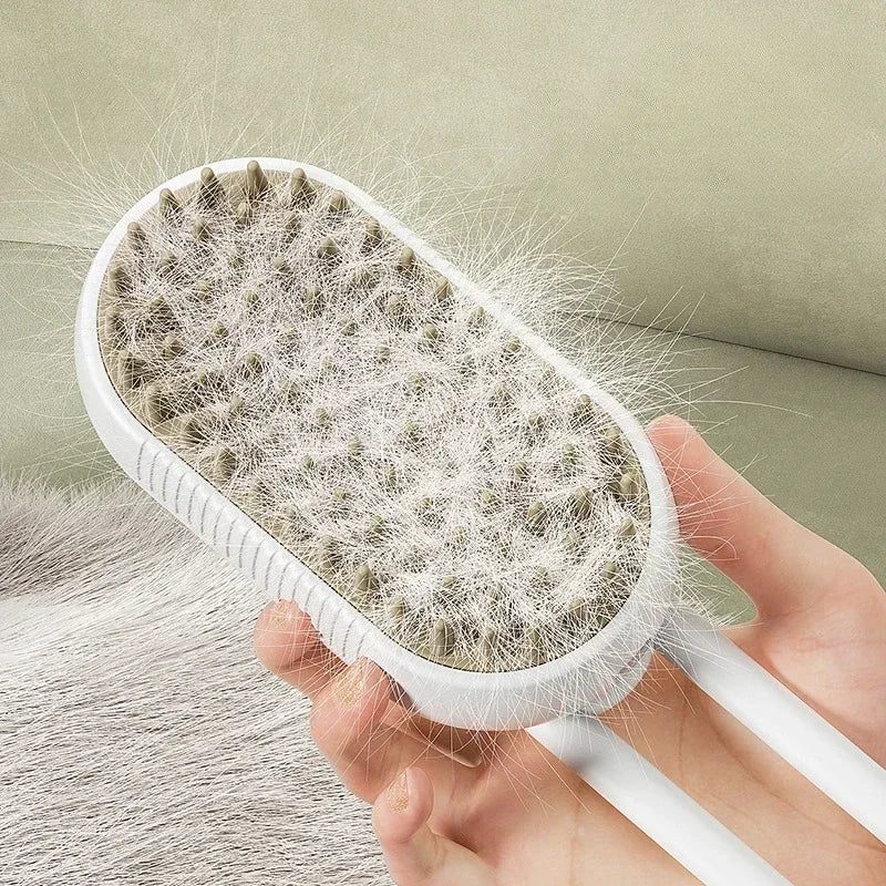 White oval pet hair remover brush with grey silicone bristles, held by hand and covered in white pet hair.