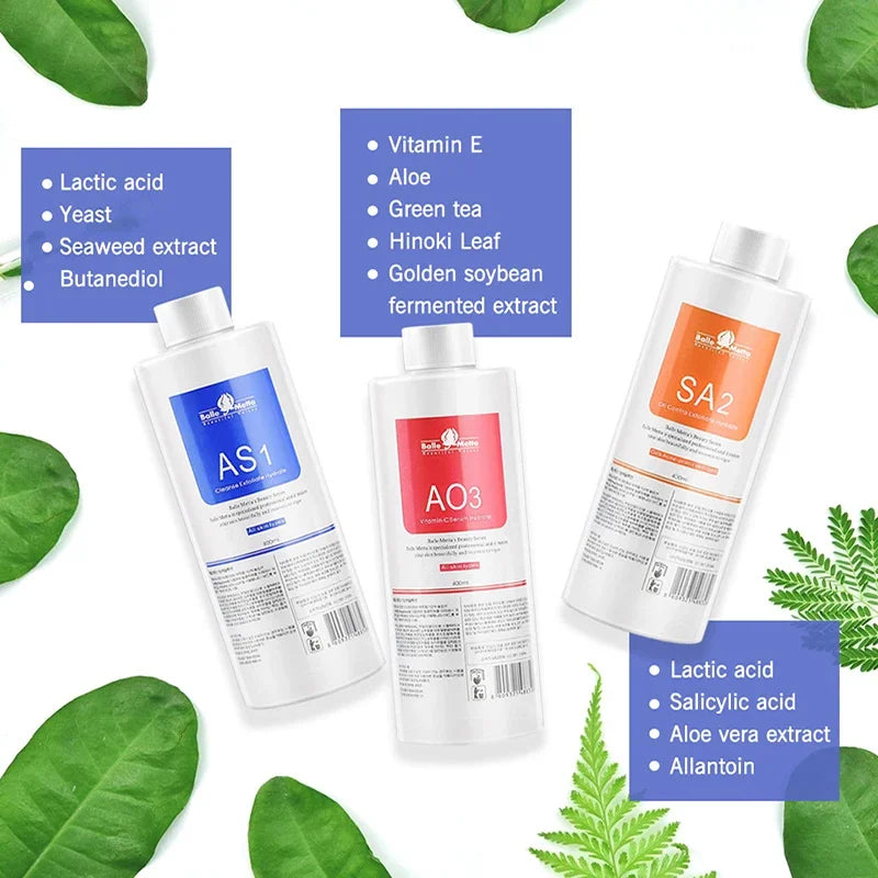 Three bottles of facial serum with blue, red, and orange labels, displayed with ingredient lists and green leaves.