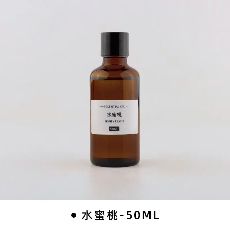 50ml amber glass bottle of honey peach essential oil with a minimalist black cap and white label.
