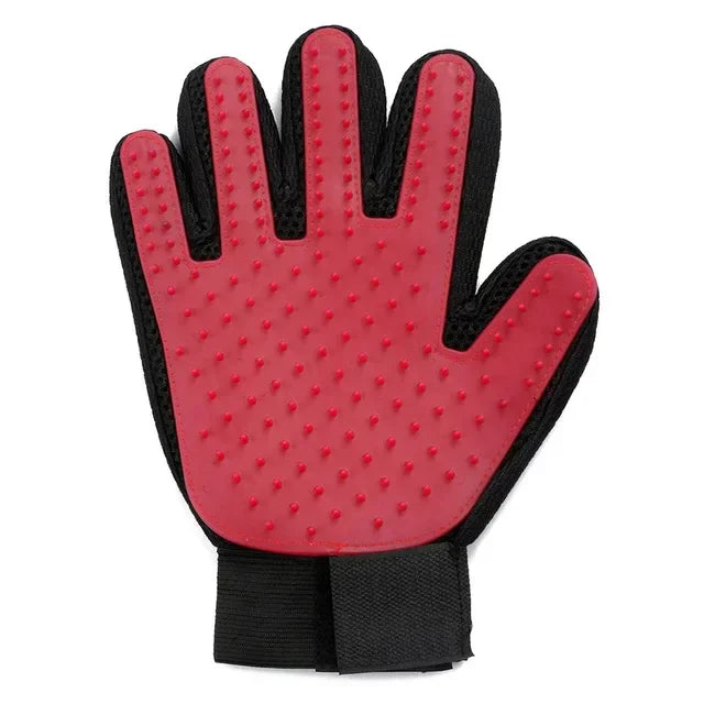Pink silicone pet grooming glove with a black mesh backing and an adjustable wrist strap.