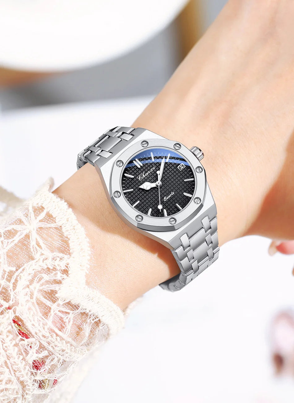 Luxury silver stainless steel analogue watch with a textured black dial and screw-detail bezel, worn on the wrist.