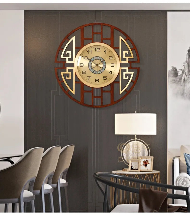 Modern wall clock with a circular, gold-toned face and geometric dark wood frame, displayed in a stylish living room.
