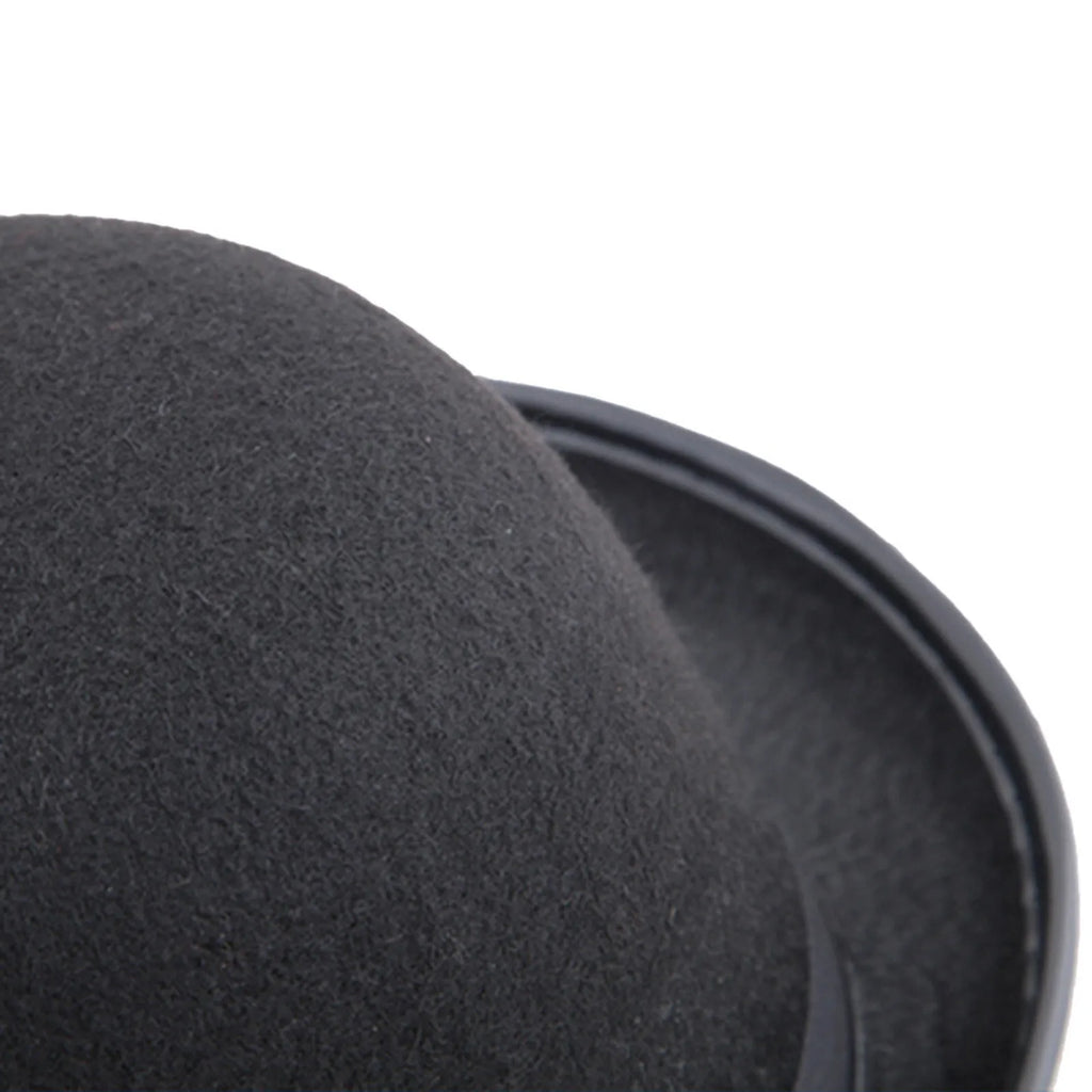 Close-up of a classic black felt fedora hat with a curved brim, set against a plain white background.