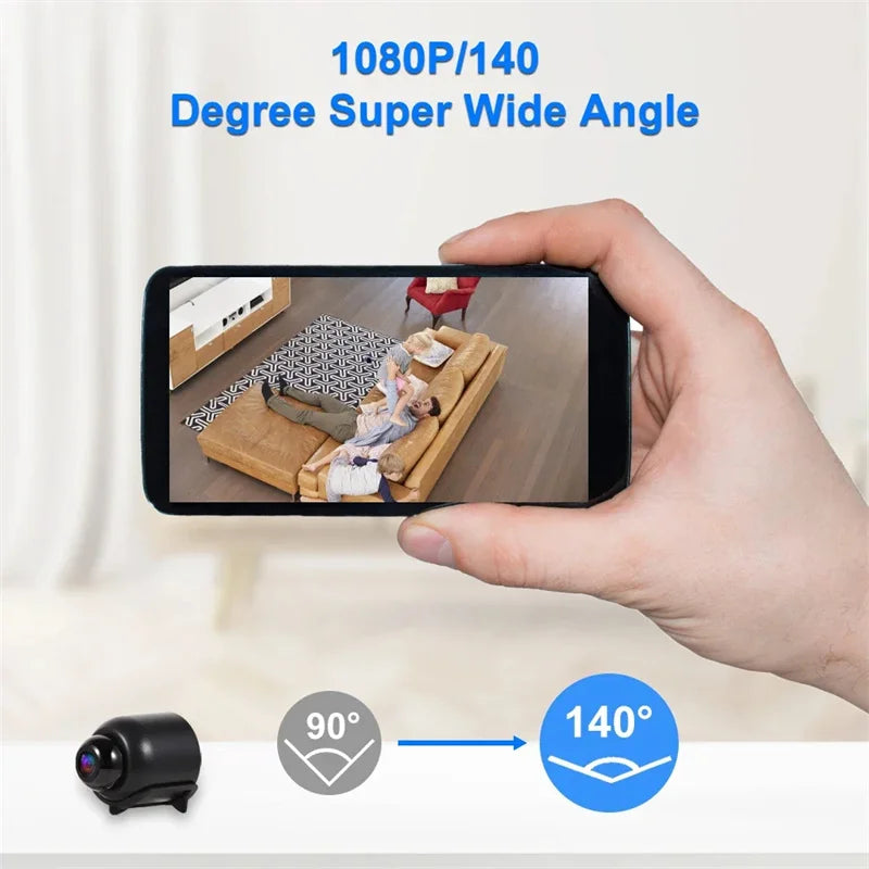 A small black plastic mini camera displayed next to a smartphone screen showing a 140-degree wide-angle living room view.