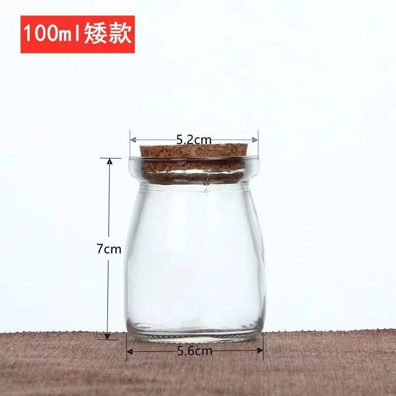 Small 100ml clear glass storage jar with a cork lid, featuring dimensions marked for height and width.