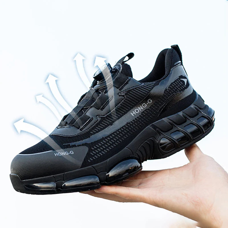 Black breathable steel-toe work trainer with a dial lace system and chunky, cushioned sole, held in a hand.