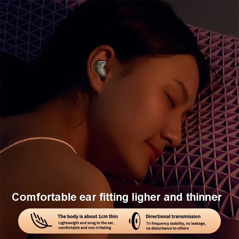 A woman sleeps wearing a small, ergonomic, silver wireless earbud designed for comfort and thin, lightweight wear.