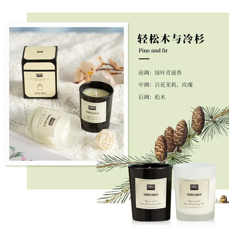 Pine and fir scented candles in black and frosted glass jars with cream labels, presented with decorative packaging.