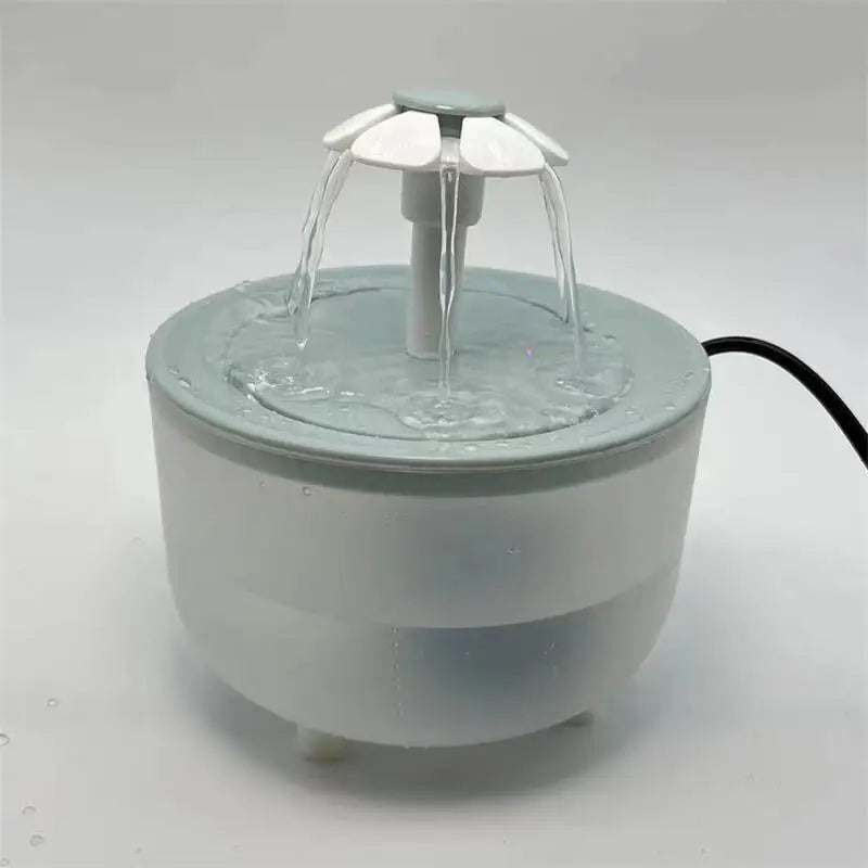 Round grey and white pet water fountain with a flower-shaped spout design on a plain background.
