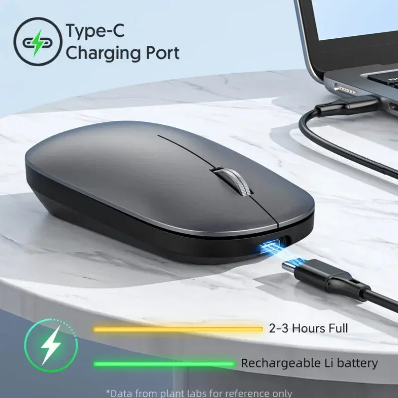 Sleek, grey wireless ergonomic mouse with a silver scroll wheel, shown charging via a Type-C cable on a marble desk.