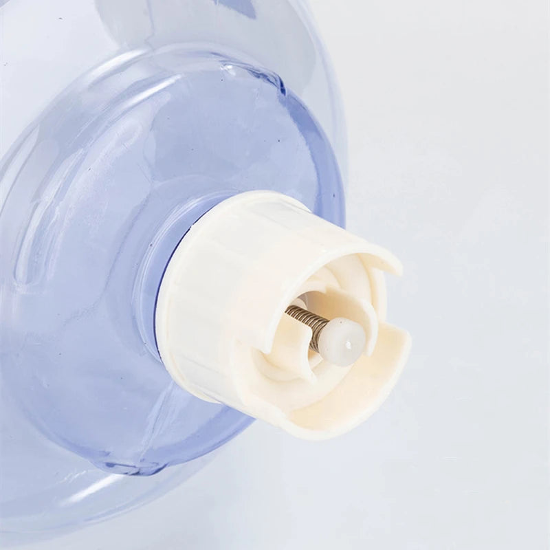Translucent blue plastic water jug nozzle with a white screw cap and spring-loaded valve mechanism.