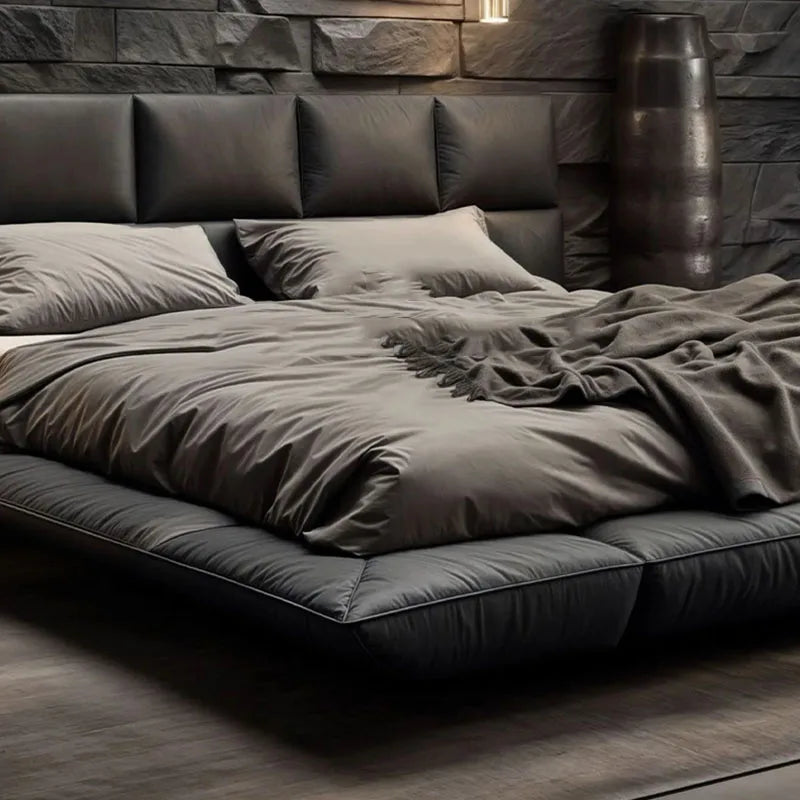 Modern charcoal grey leather floating king bed with a sleek, low-profile frame and a cushioned headboard.