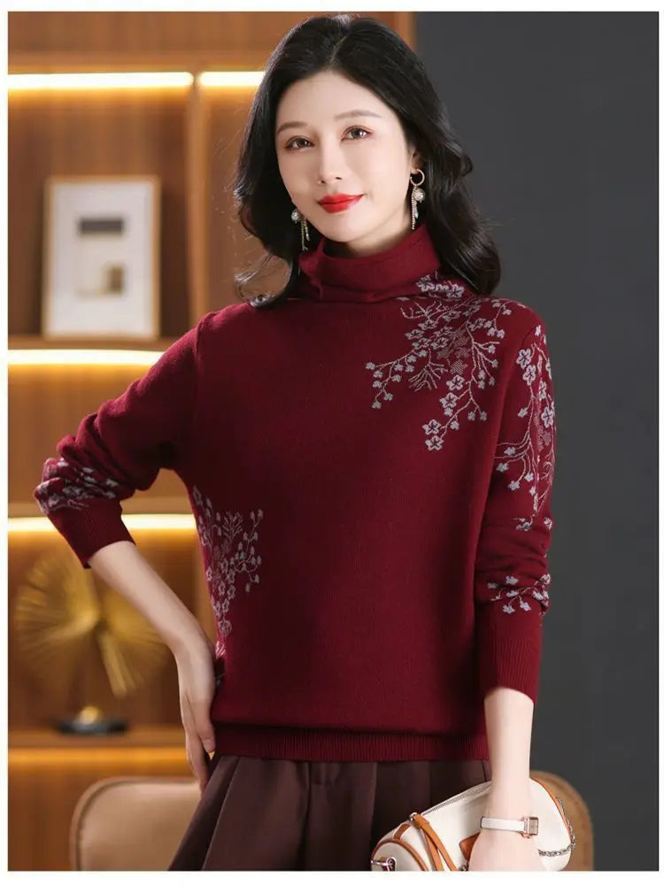 Burgundy turtleneck jumper with silver-grey floral embroidery on the shoulder and sleeve, long sleeves, and ribbed trim.