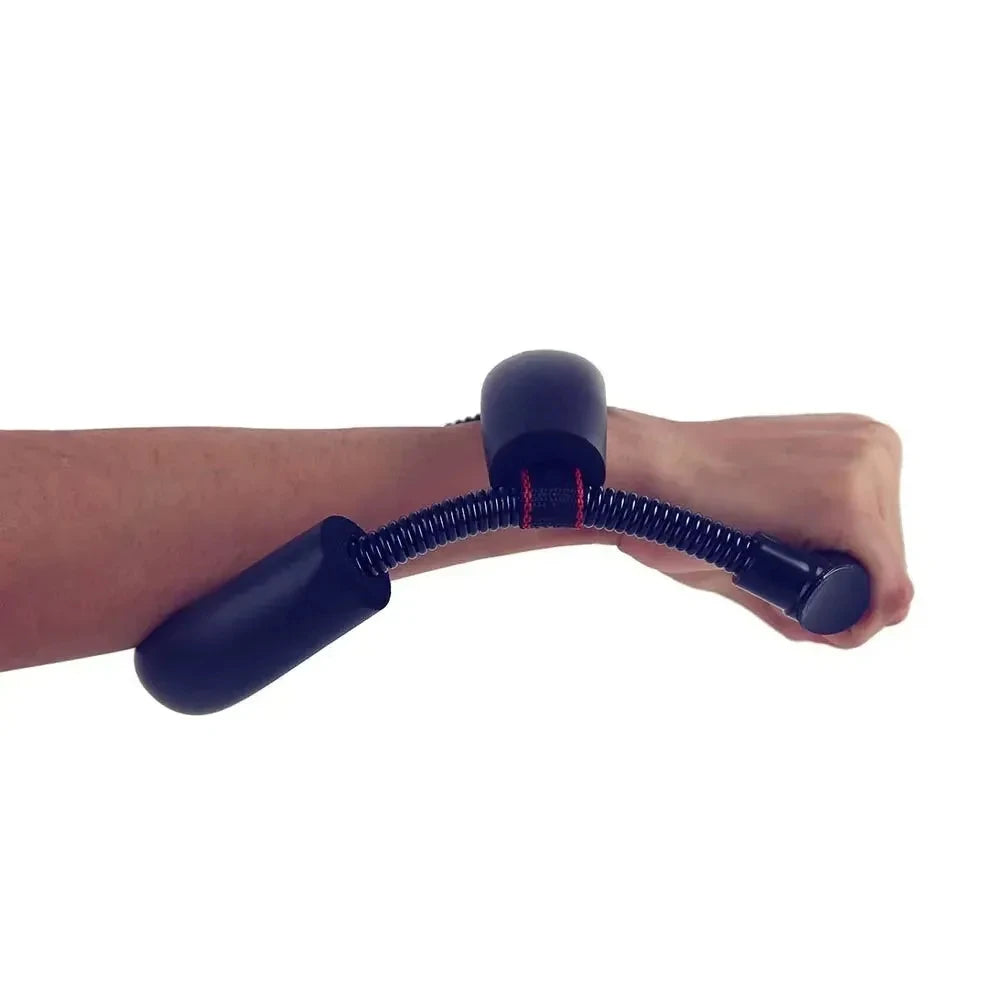 Black wrist strength trainer with coiled spring and foam padding, being held on a person's forearm.