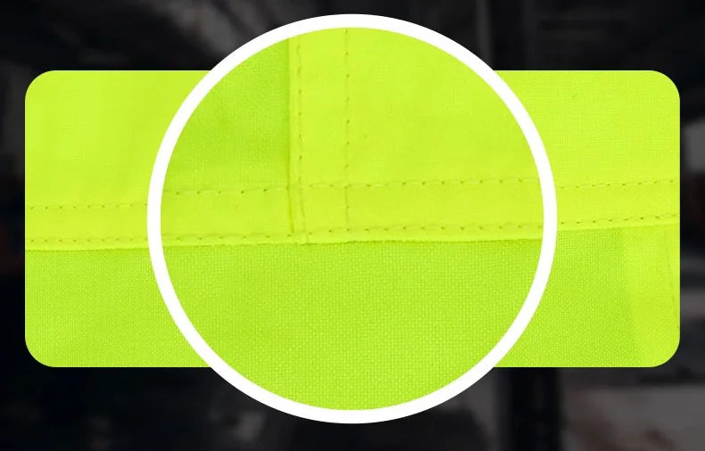 Close-up of durable neon yellow hi-vis workwear fabric with reinforced stitching.
