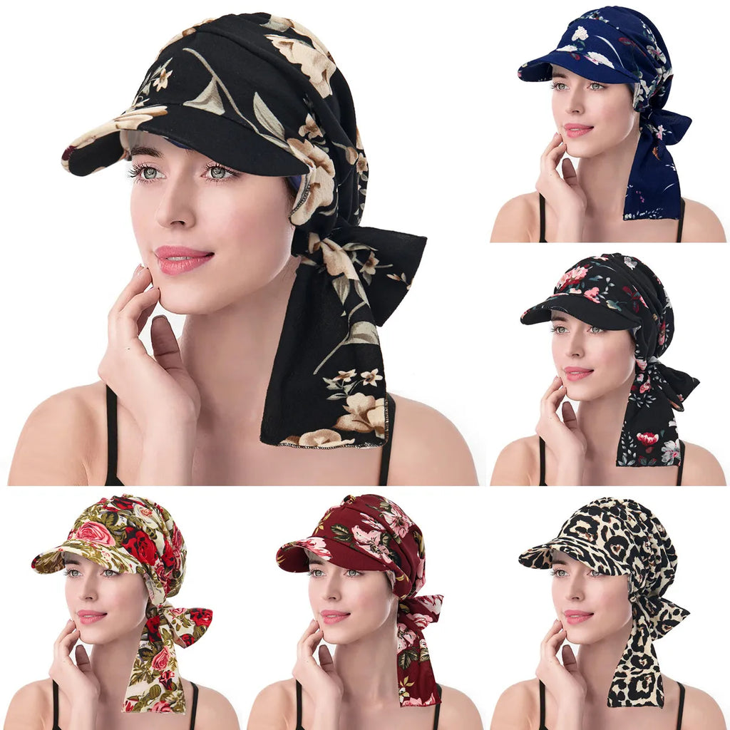 Model wearing vintage-style turban hats with brims, available in various floral and animal print patterns.
