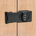 Black metal safety hasp lock with a three-digit combination dial, mounted on light wood-grain cabinet doors.
