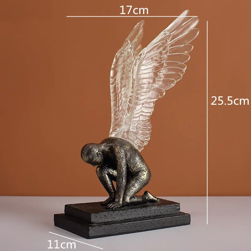 Textured bronze-effect kneeling figure ornament featuring striking, translucent angel wings on a sturdy rectangular base.