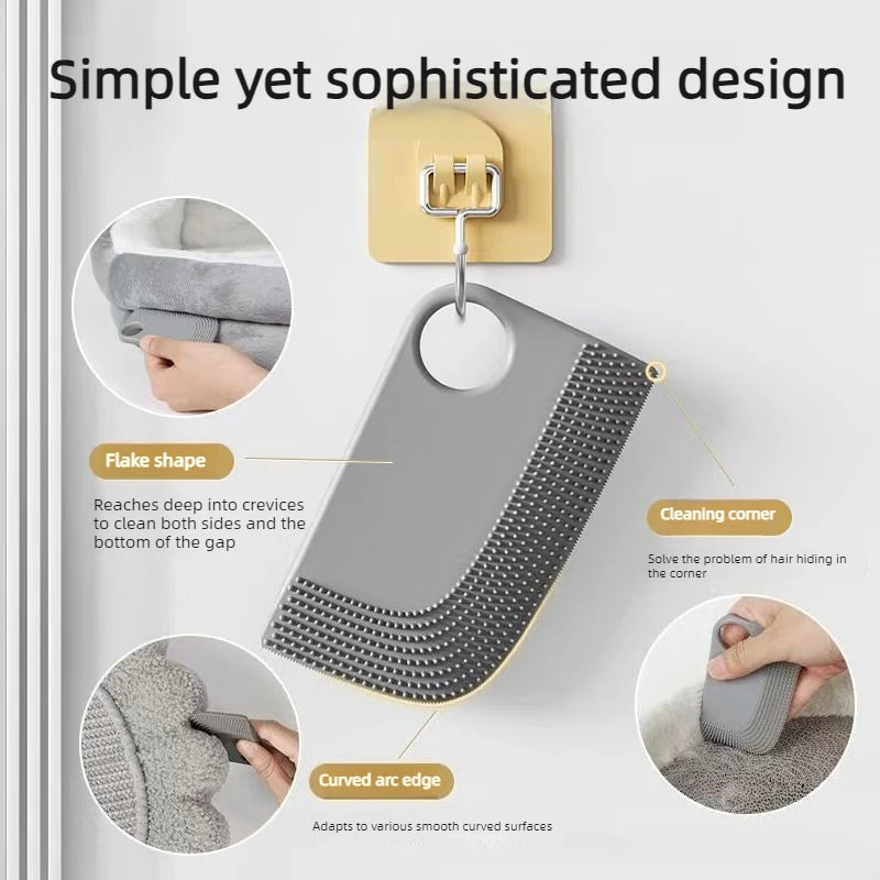 Grey silicone pet hair remover tool with a hanging hook, textured surface, and curved edge for cleaning crevices.