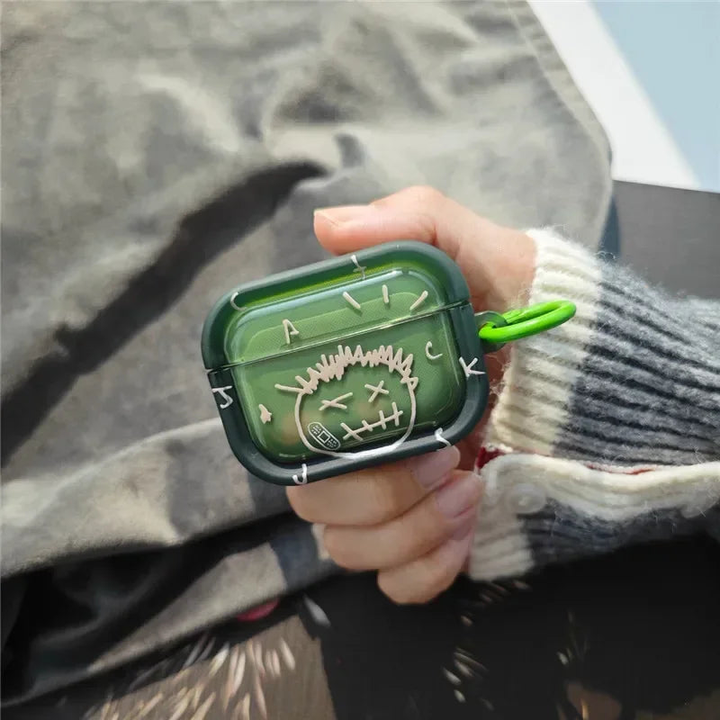Translucent green silicone case for AirPods Pro with white stitched-effect character graphic and green carabiner.