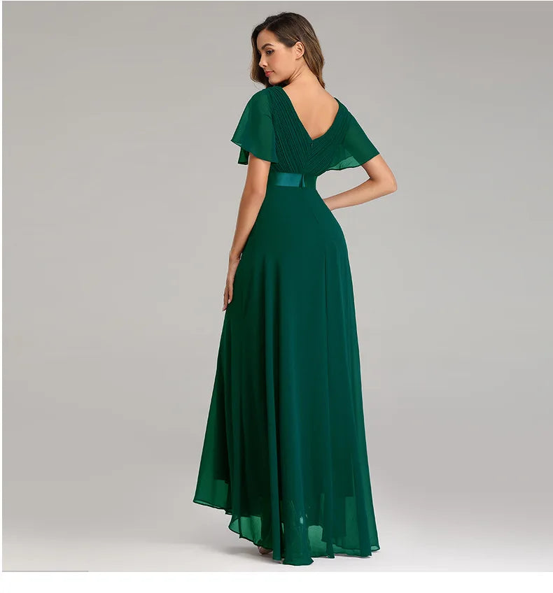 Dark green chiffon maxi dress featuring short flutter sleeves, a V-back, and a cinched waistline.