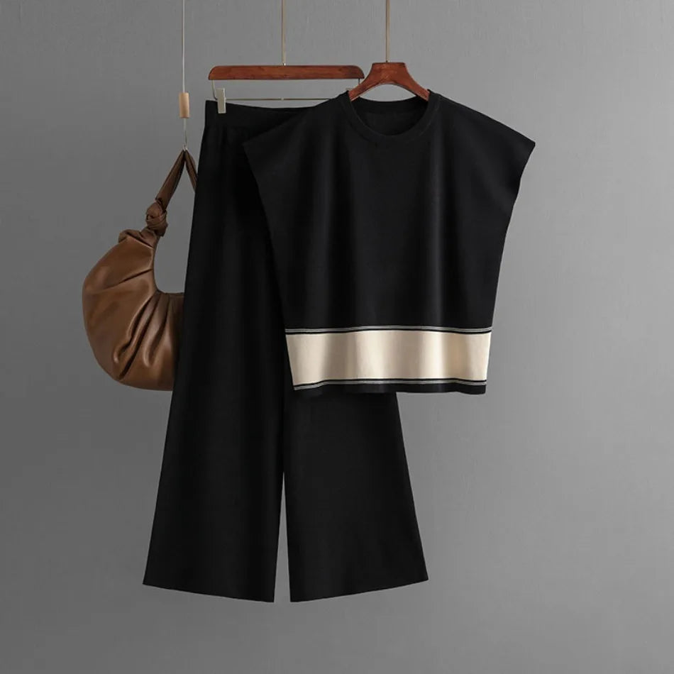 Black two-piece set with a boxy sleeveless top featuring a cream stripe and matching wide-leg trousers.