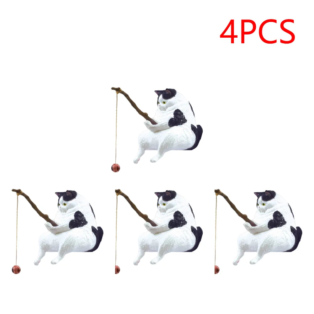 A set of four black and white cat ornaments, each sitting and holding a small fishing rod with a tiny bobber.