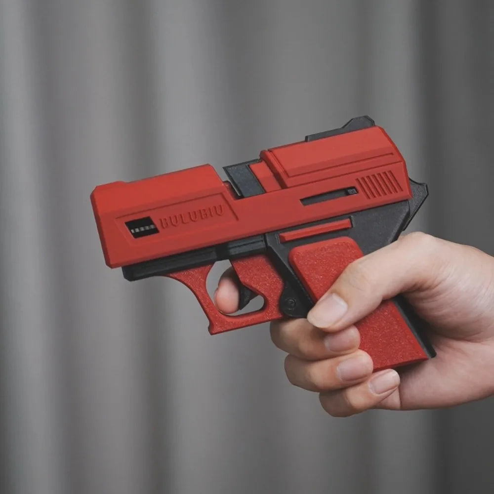 Red and black textured silicone AirPods case in a novelty pistol gun design held in a hand.