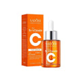 Brightening vitamin C face serum in a 30ml amber glass dropper bottle with its matching orange retail box.