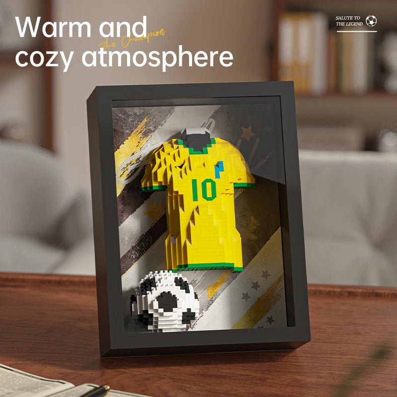 Framed wall art featuring a 3D block-style yellow football jersey with number 10 and a soccer ball on a textured back.