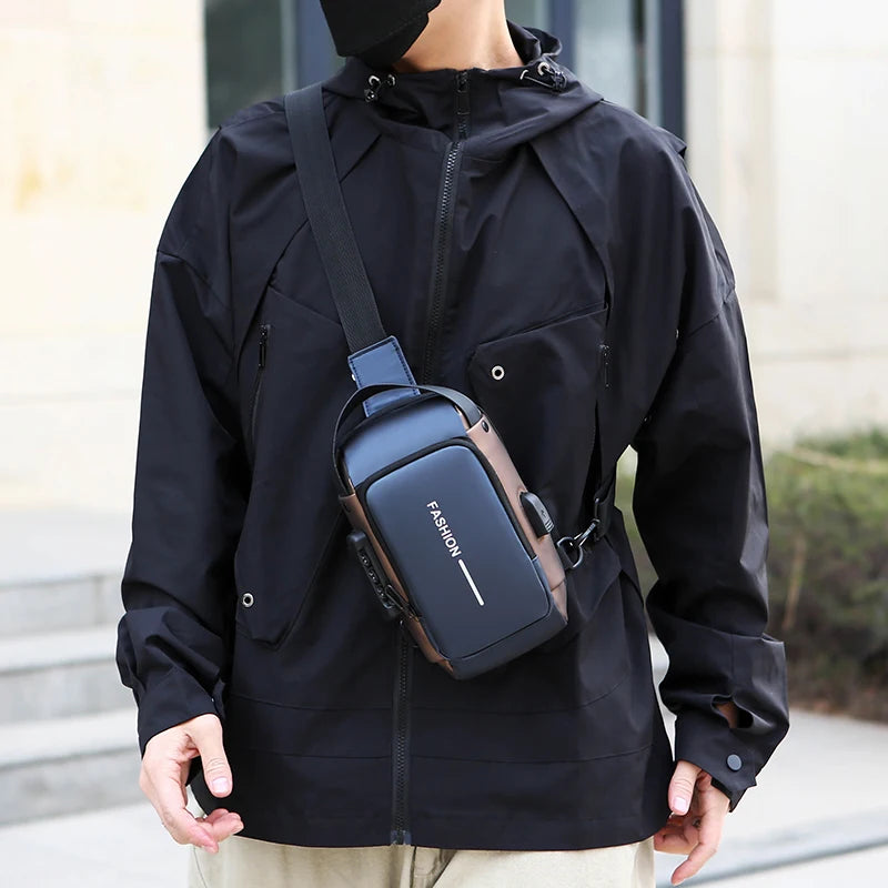 A sleek navy and brown anti-theft crossbody chest bag with an integrated USB charging port worn over a black jacket.