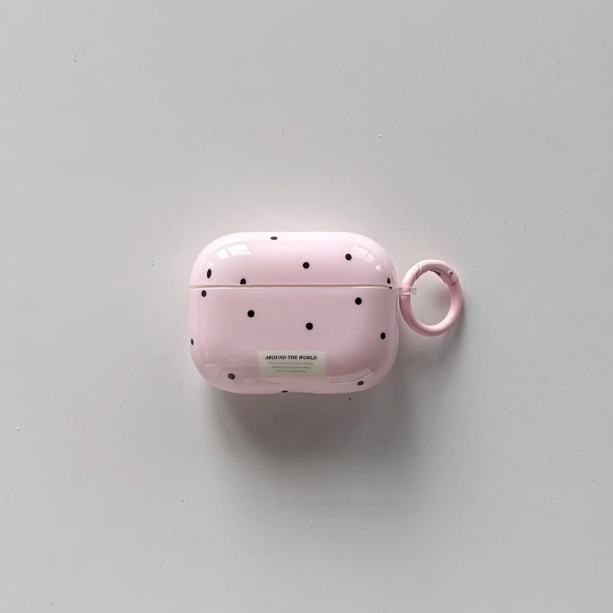 Pink polka-dot hard shell AirPods Pro case with a matching side keyring loop.