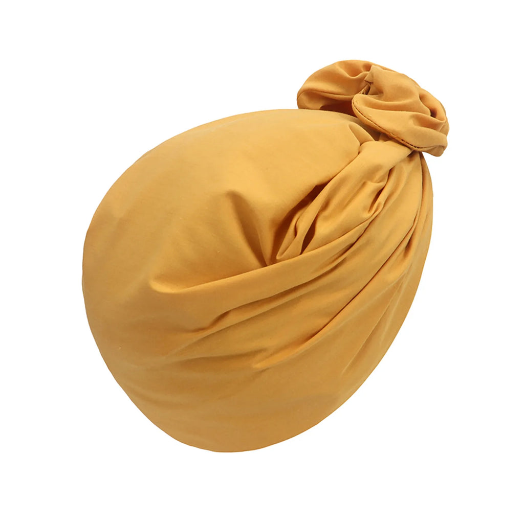 Mustard yellow French-style vintage turban hat with a gathered knotted detail, set against a plain white background.