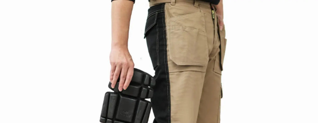 Men’s beige and black multi-pocket cargo work trousers, featuring side leg panels and a protective knee pad.
