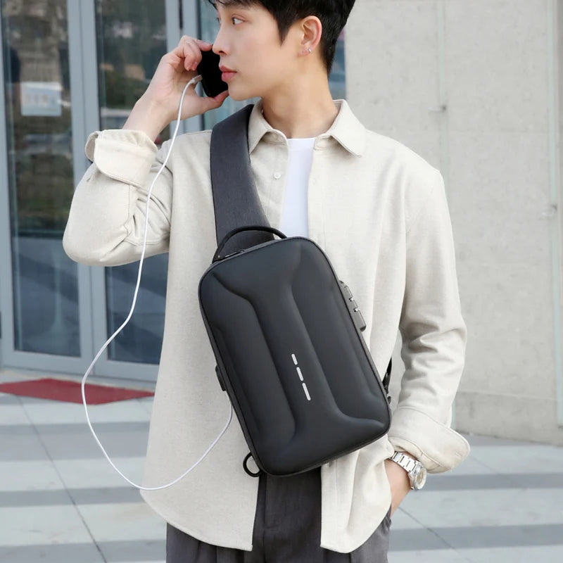 A man wearing a sleek, black anti-theft crossbody bag with a built-in USB charging port and a secure combination lock.