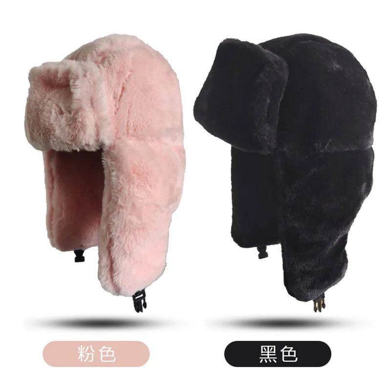 Two fluffy faux-fur trapper hats in baby pink and black, featuring ear flaps and adjustable chin straps.