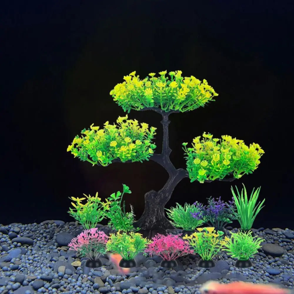 Artificial aquarium plants featuring a large, yellow-leafed tree and several smaller, colorful shrub-like plants.