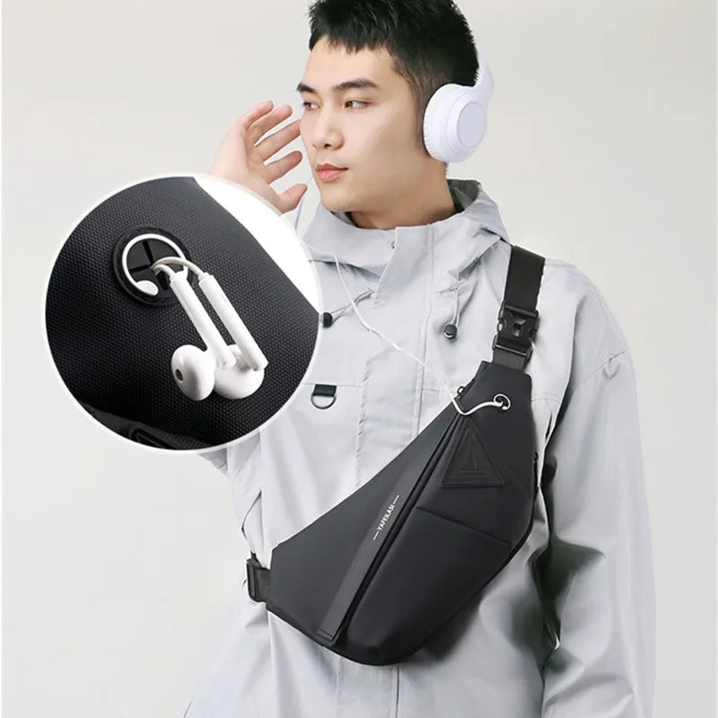 A man wearing a black, sleek anti-theft crossbody sling bag with a built-in earphone cable port.