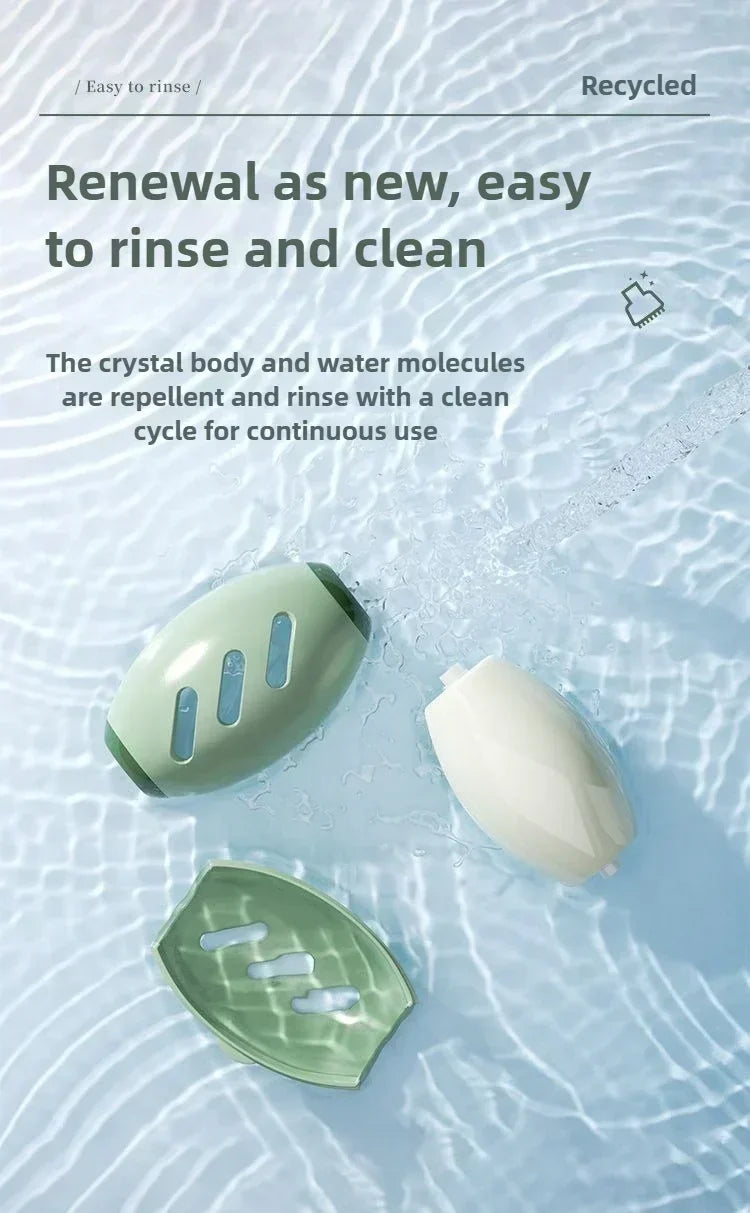 Two sage green and white soap dishes, one disassembled, submerged in water with a rinse cycle background.